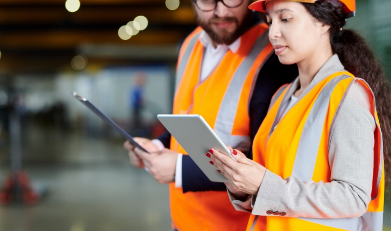 Compliance workers wearing orange vests