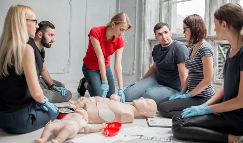 Students giving CPR to a dummy