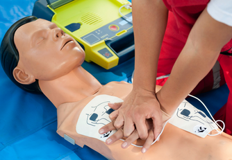 Person giving CPR to a dummy