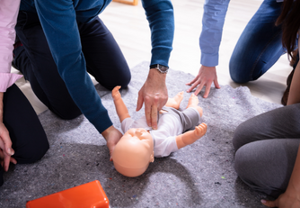 Student giving CPR to fake baby
